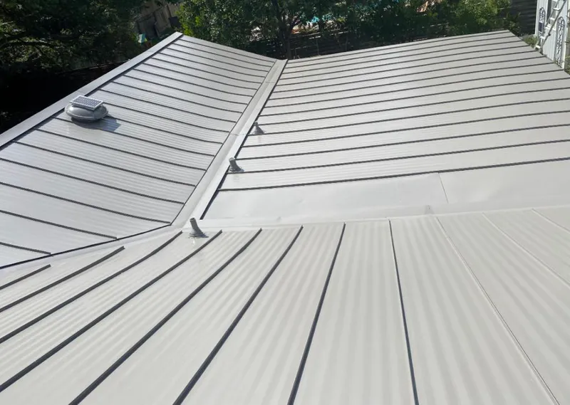 Solar attic fan installed on a metal roof for Roof Ventilation in Lower